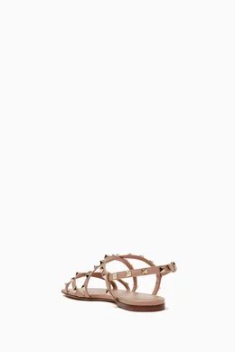 Buy Valentino Garavani Pink Valentino Garavani Rockstud Strappy Flat Sandals in Calfskin For Women Online Ounass Bahrain