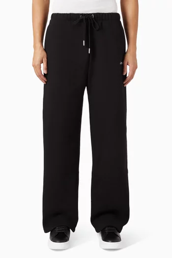 بنطال رياضي بقصة ساق واسعة وشعار الماركة مزيج قطن